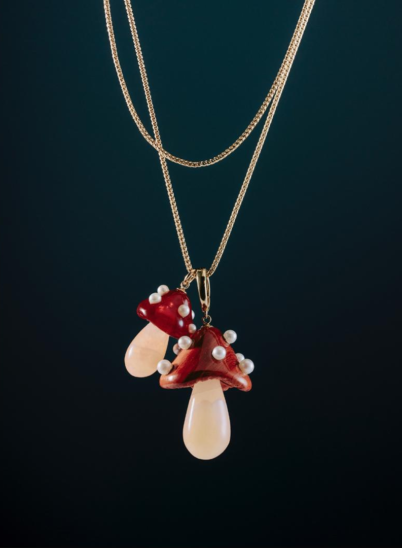 Necklace with red and beige pendant on a dark background