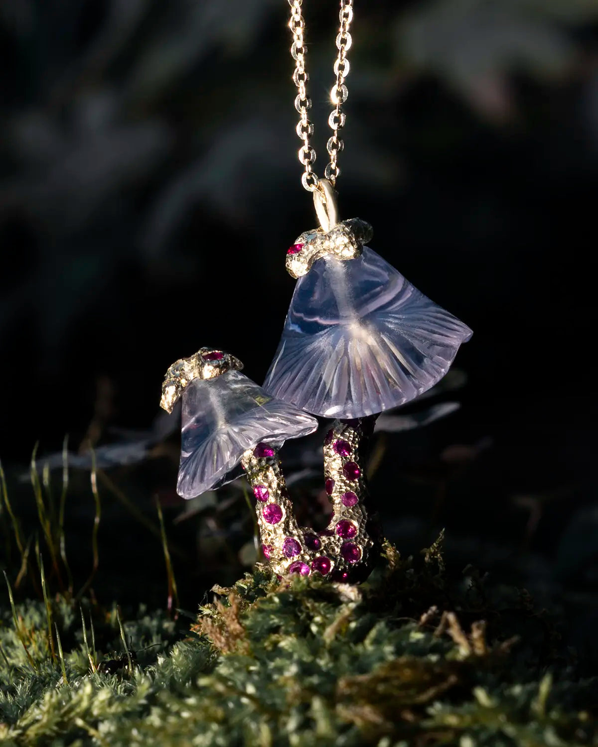 Mushroom-shaped necklace with gemstones on a dark background