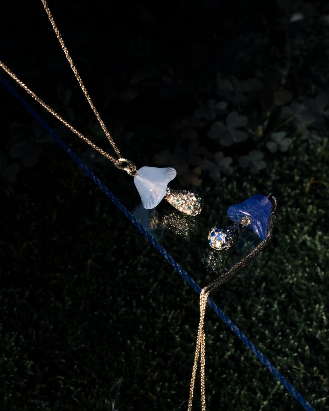 Necklace with blue pendant on a dark textured surface